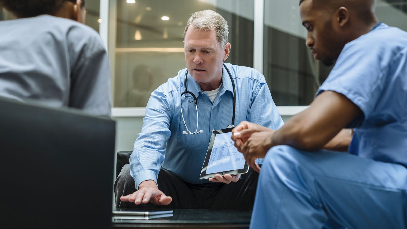 Doctor using iPad for NHS login authentication